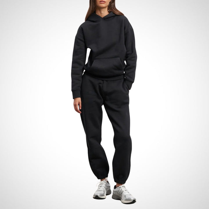Two-piece hoodie and jogger set in black, worn on a model