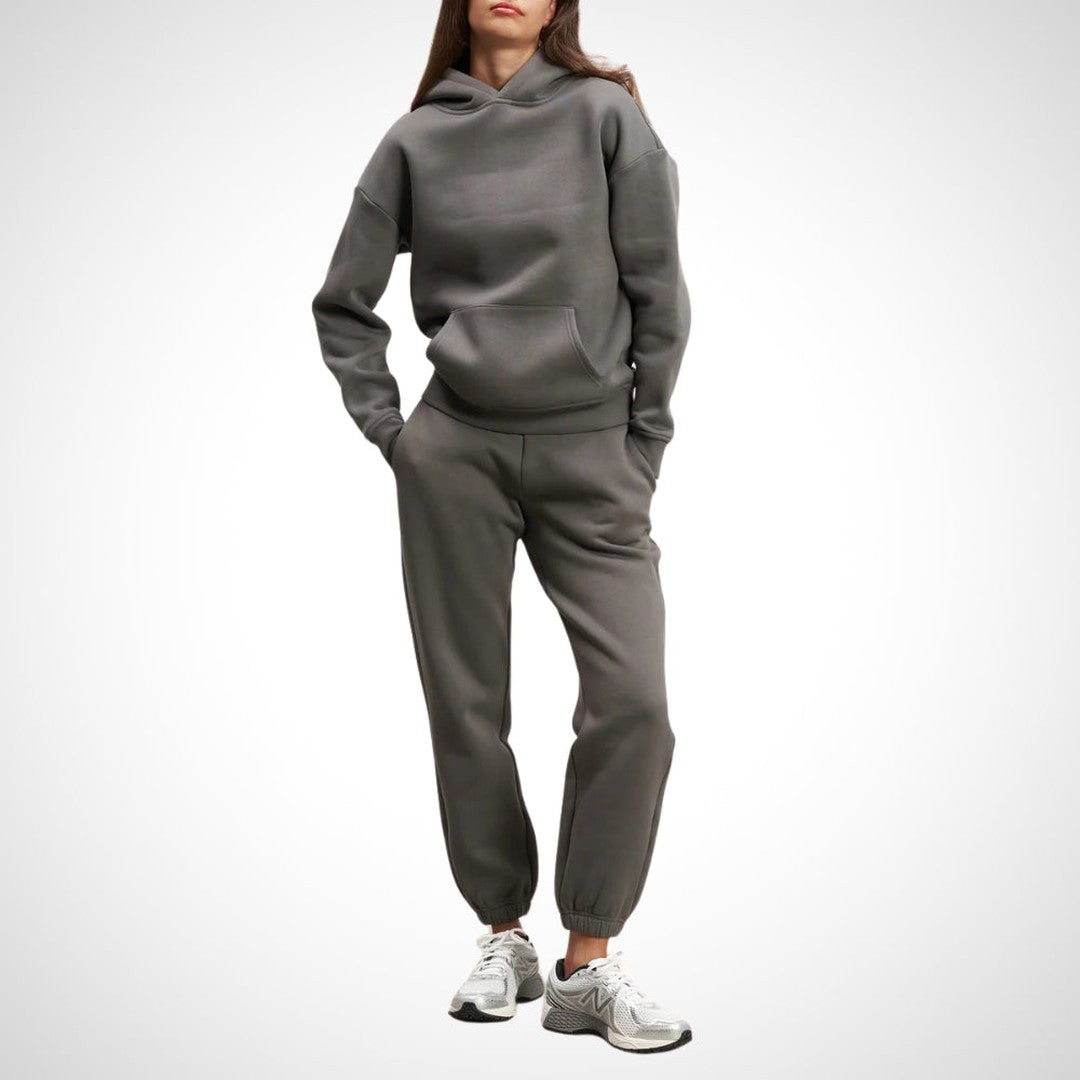 Two-piece hoodie and jogger set in dark grey, worn on a model