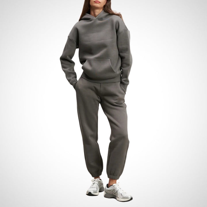 Two-piece hoodie and jogger set in dark grey, worn on a model